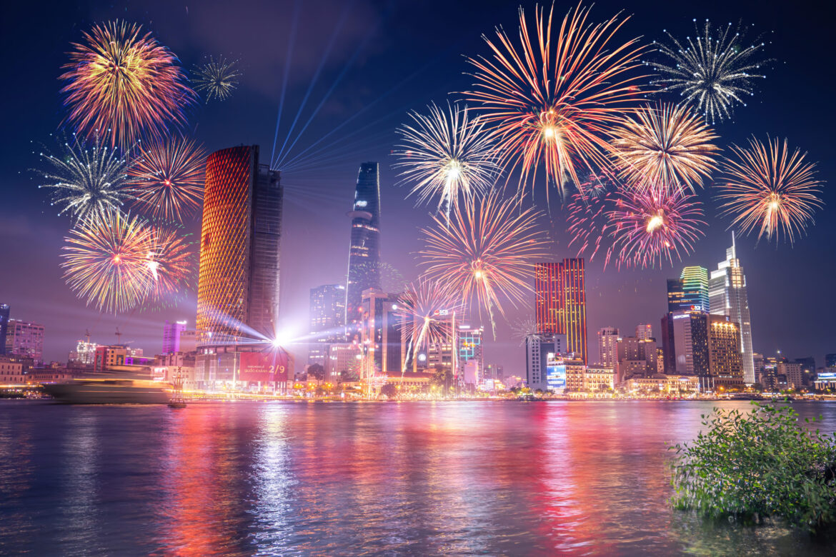 Celebration. Skyline with fireworks light up sky over business district in Ho Chi Minh City ( Saigon ), Vietnam. Beautiful night view cityscape. Holidays, independence day, New Year and Tet holiday