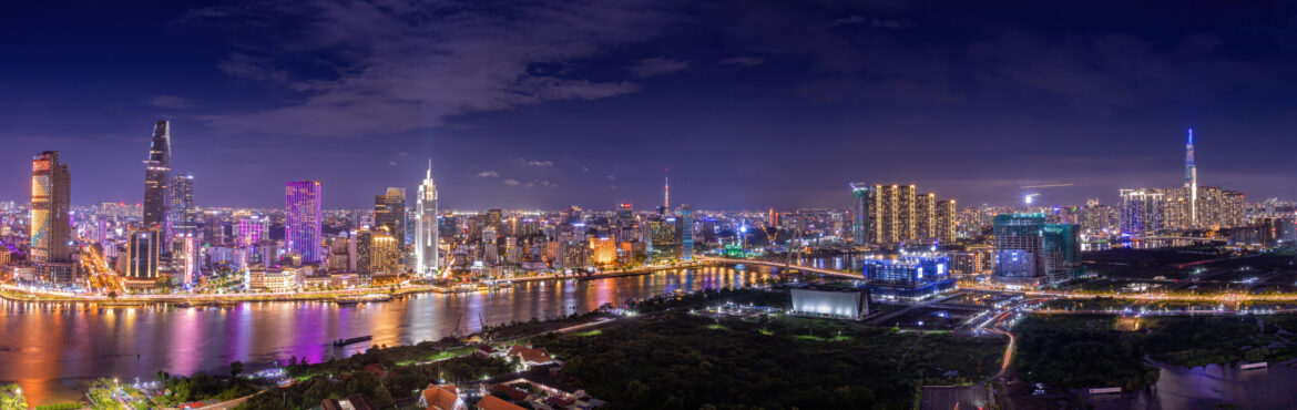 Aerial view of Bitexco Tower, buildings, roads, Thu Thiem 2 bridge and Saigon river in Ho Chi Minh city - Far away is Landmark 81 skyscraper. Travel concept.